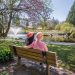 Two people sit on a bench in VanDusen Botanical Garden.